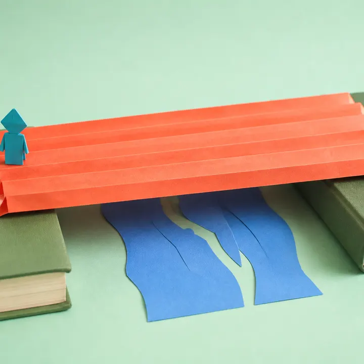 A paper traveller resting under a folded roof